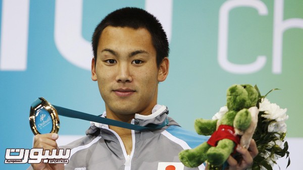 File photo of gold medallist Tomita of Japan posing after the men's 200m breaststroke final at the 10th FINA World Swimming Championships (25m) in Dubai